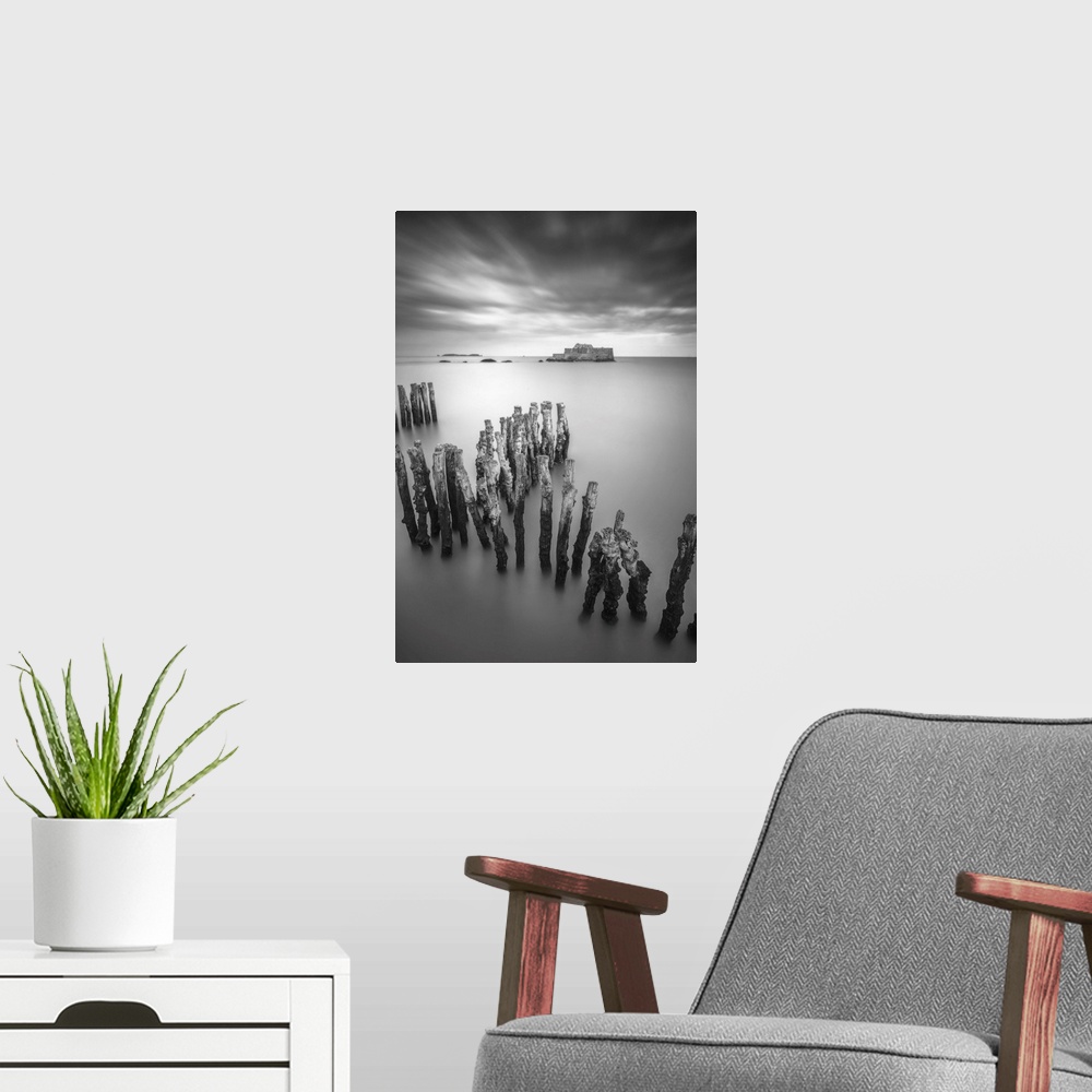 A modern room featuring Black and white vertical long time exposure view of the shorecoast of Saint Malo in Brittany, a v...