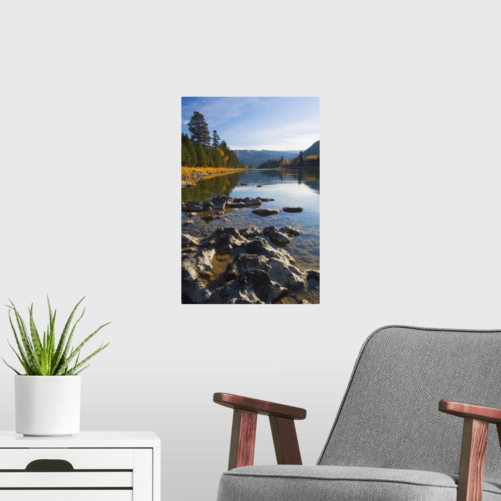 A modern room featuring Clouds and distant mountains reflected in rocky Kootenai River, Montana