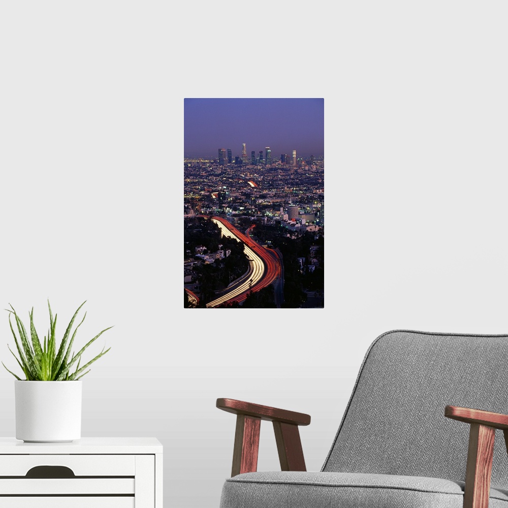 A modern room featuring Vertical panoramic of highway running through busy west coast metropolis with city skyline in dis...