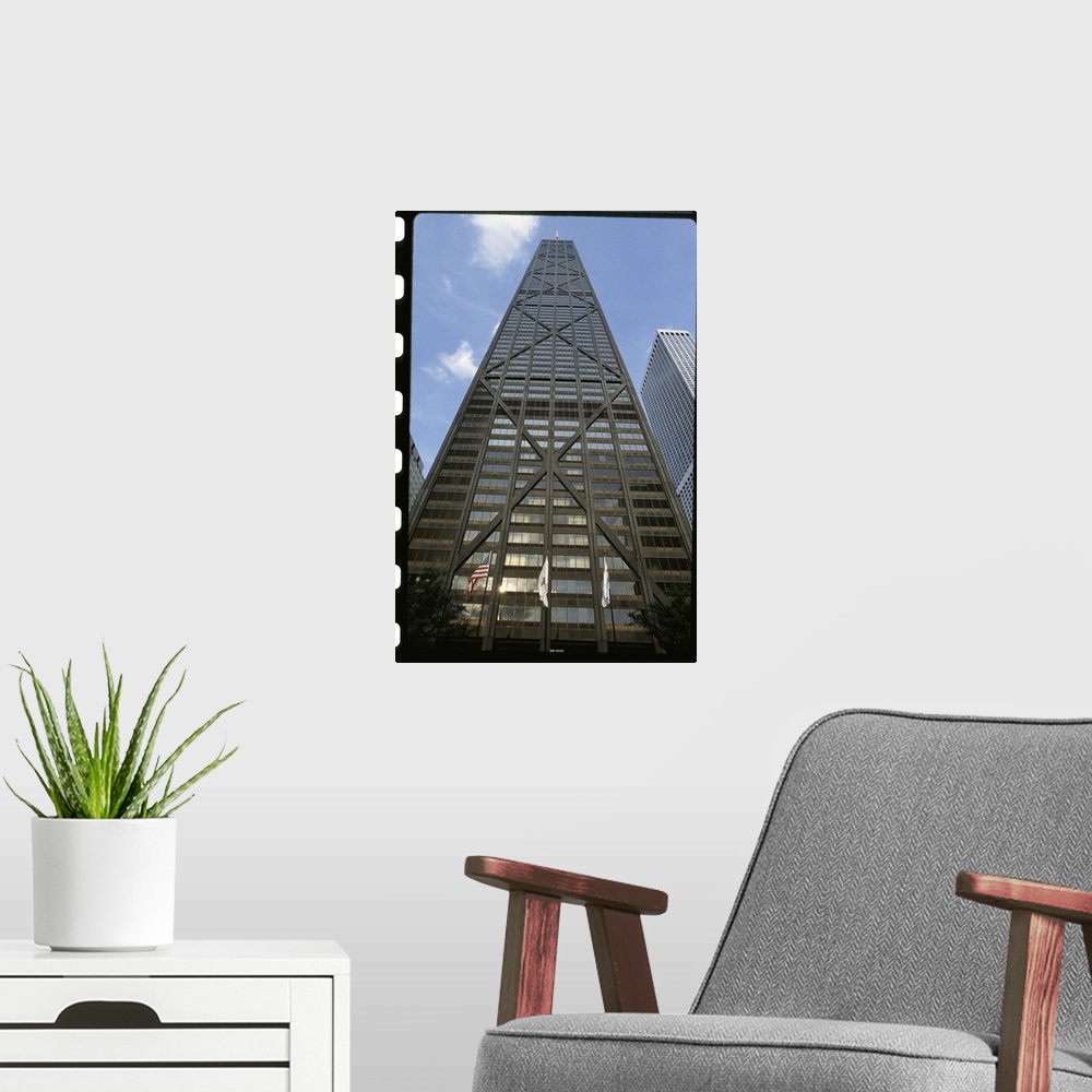A modern room featuring Vertical photograph from below of the Hancock building during the day in Chicago, Illinois.