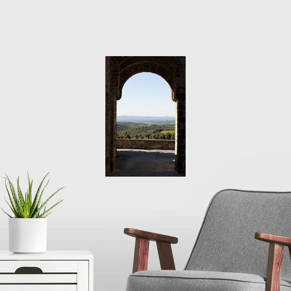 A modern room featuring Landscape viewed through an arch, San Gusme, Tuscany, Italy