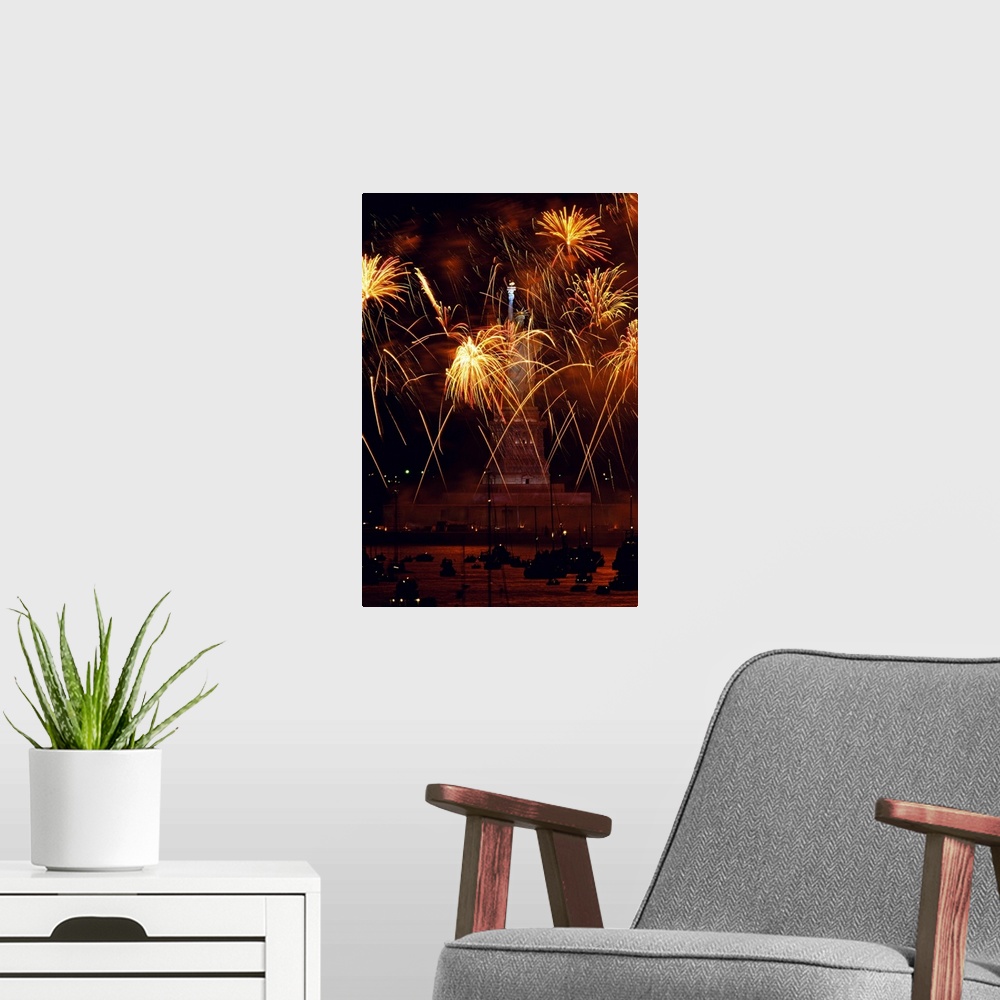 A modern room featuring Vertical, oversized photograph of fireworks exploding in front of the Statue of Liberty, as many ...