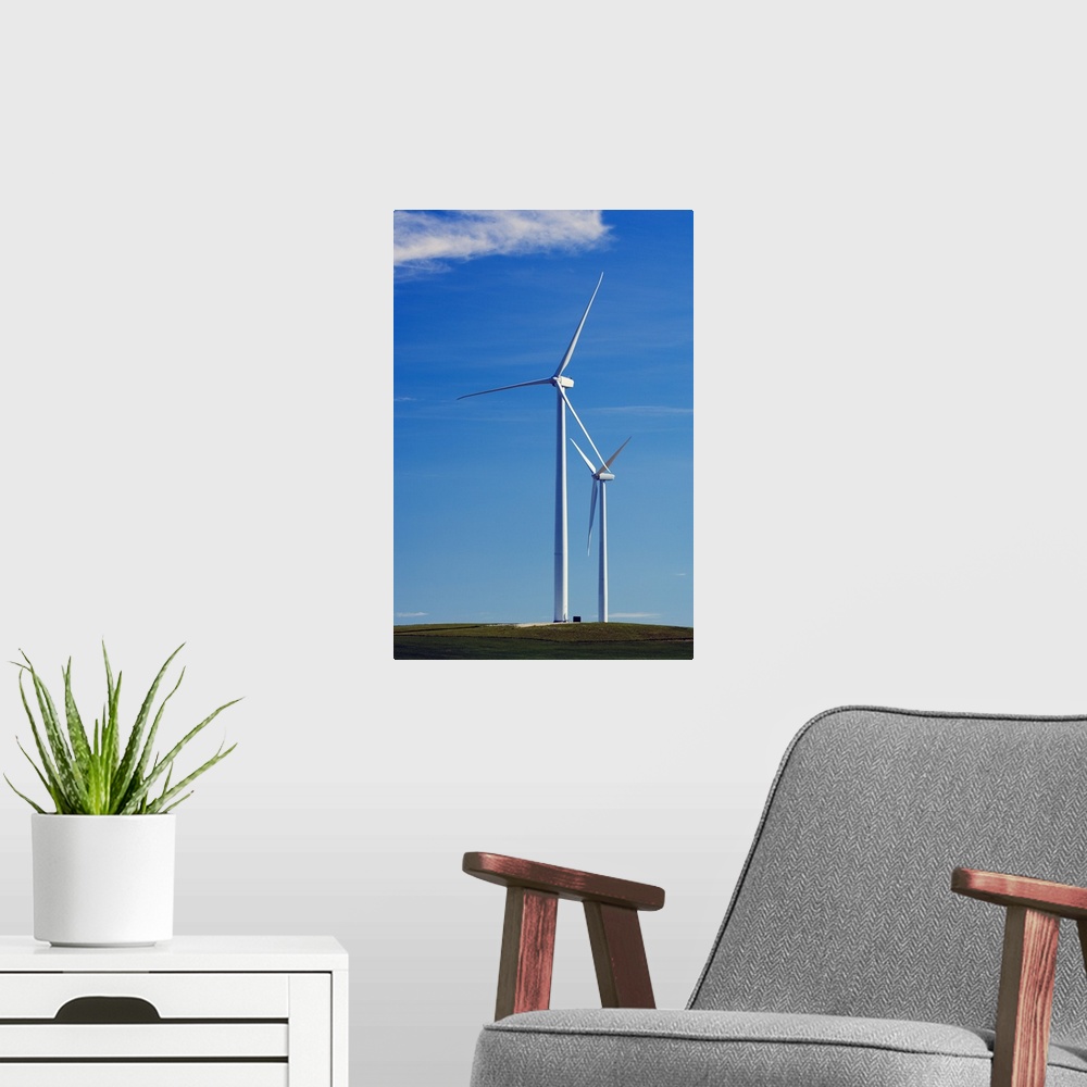 A modern room featuring Pair of wind farm turbines in green grass, blue sky, Montana