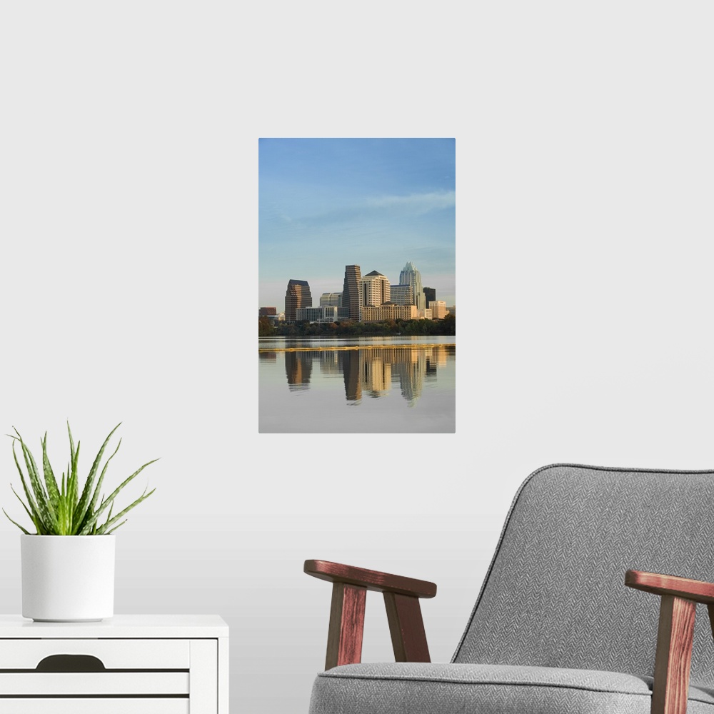 A modern room featuring Skyscrapers in Austin reflect down in the body of water that sits just in front of the city.
