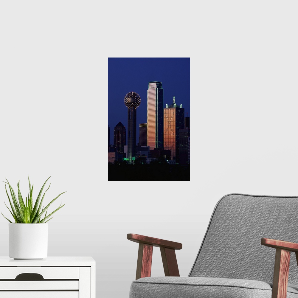 A modern room featuring This large vertical piece is a photograph that has been taken of the Dallas skyline with the buil...