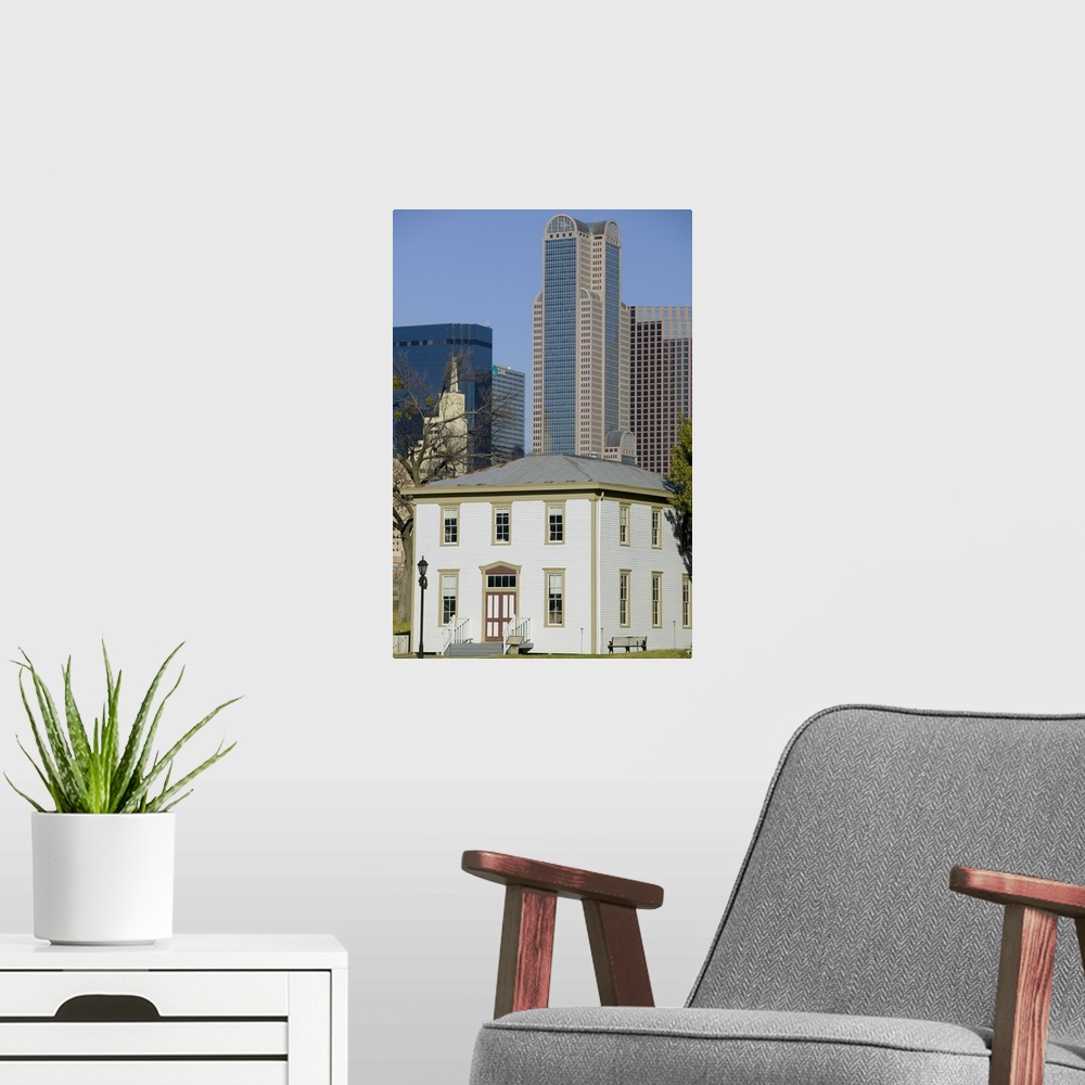 A modern room featuring Skyscrapers behind an old house, Old City Park, Dallas, Texas