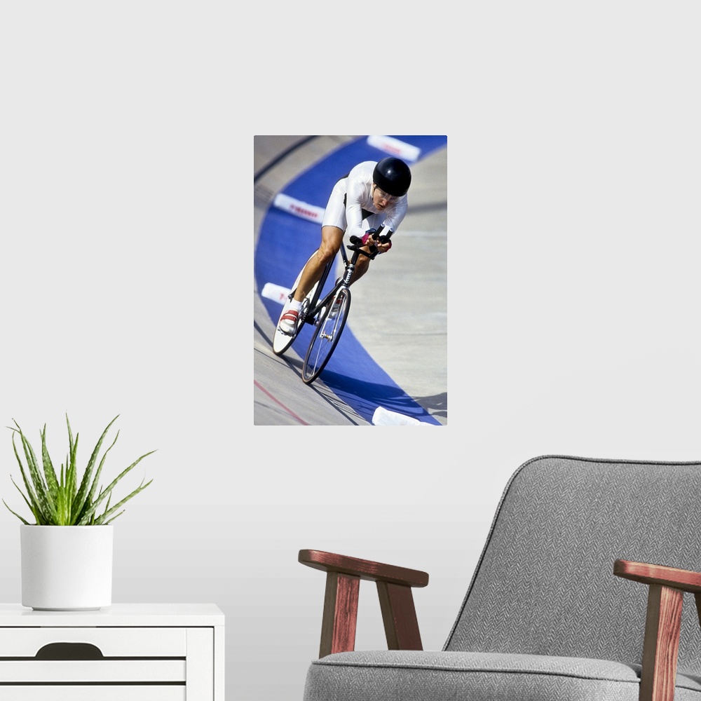 A modern room featuring Female cyclist racing on the velodrome track