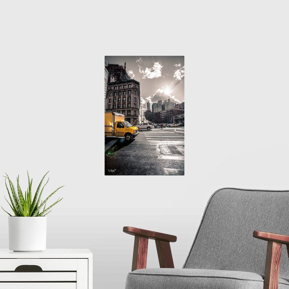 A modern room featuring Photograph of a yellow truck popping against a subdued city street scene.