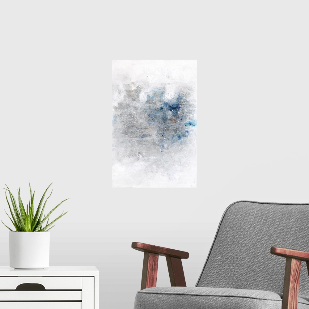A modern room featuring Large contemporary abstract artwork with silver and blue hues in the middle of a white background...