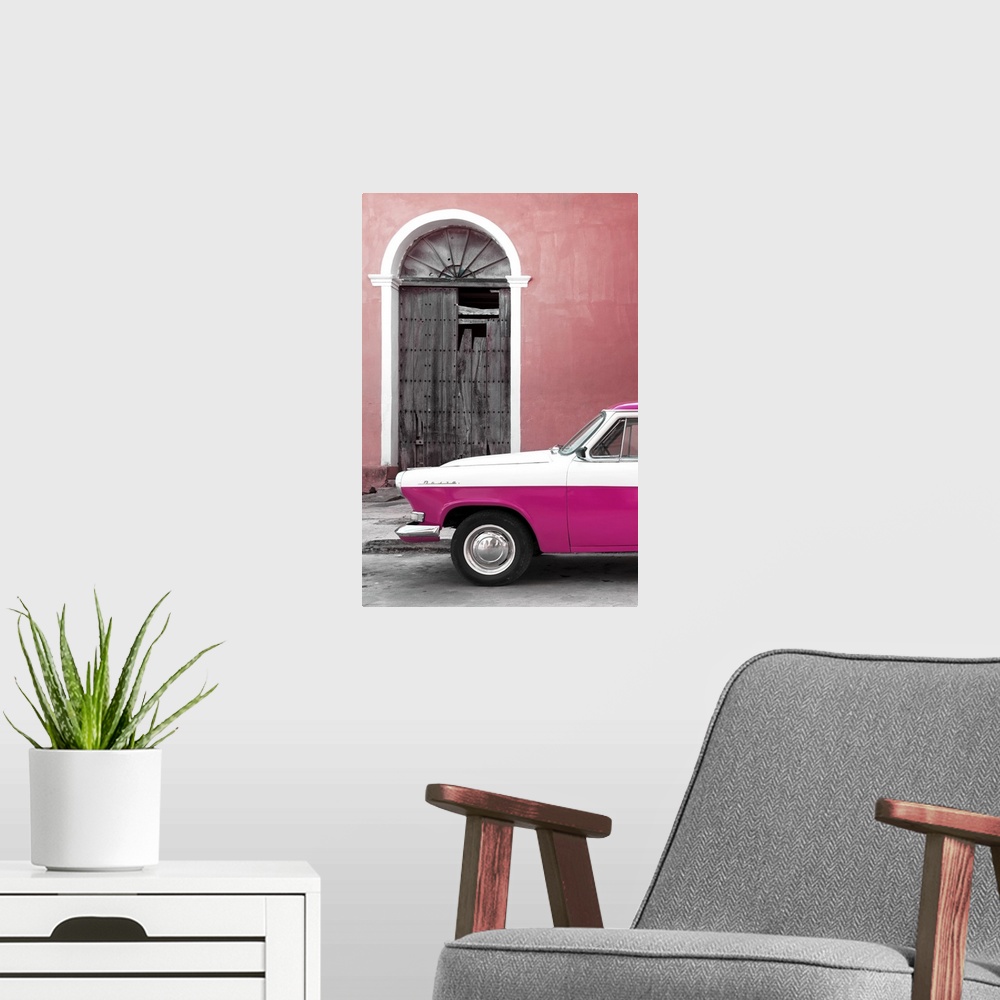 A modern room featuring Photograph of the front of a vintage pink and white car outside of a pink building with a broken ...