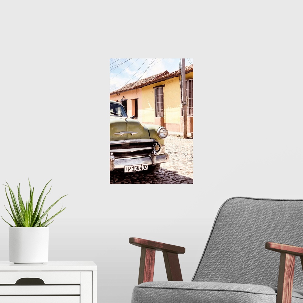 A modern room featuring Photograph of the front side of an old Chevy in the streets of Havana.