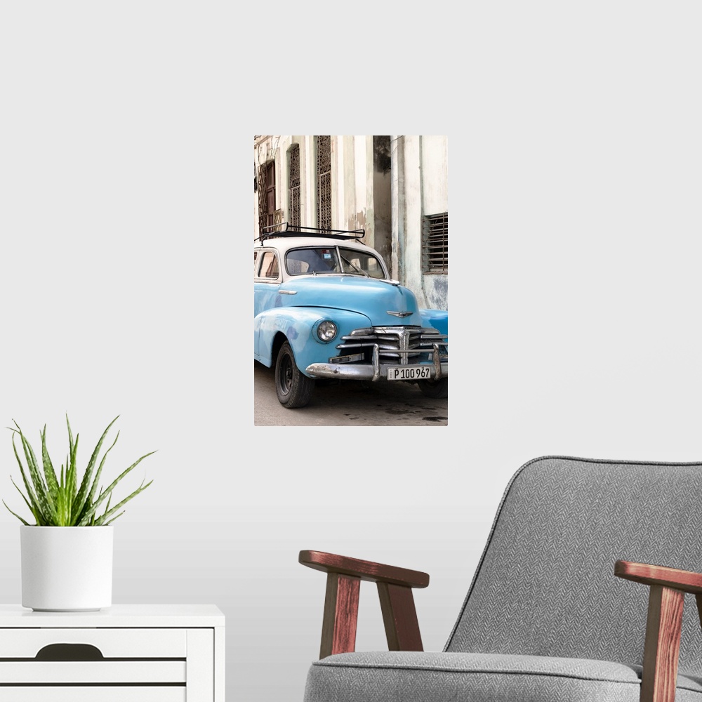 A modern room featuring Photograph of a blue vintage Chevrolet parked outside in the streets of Havana.
