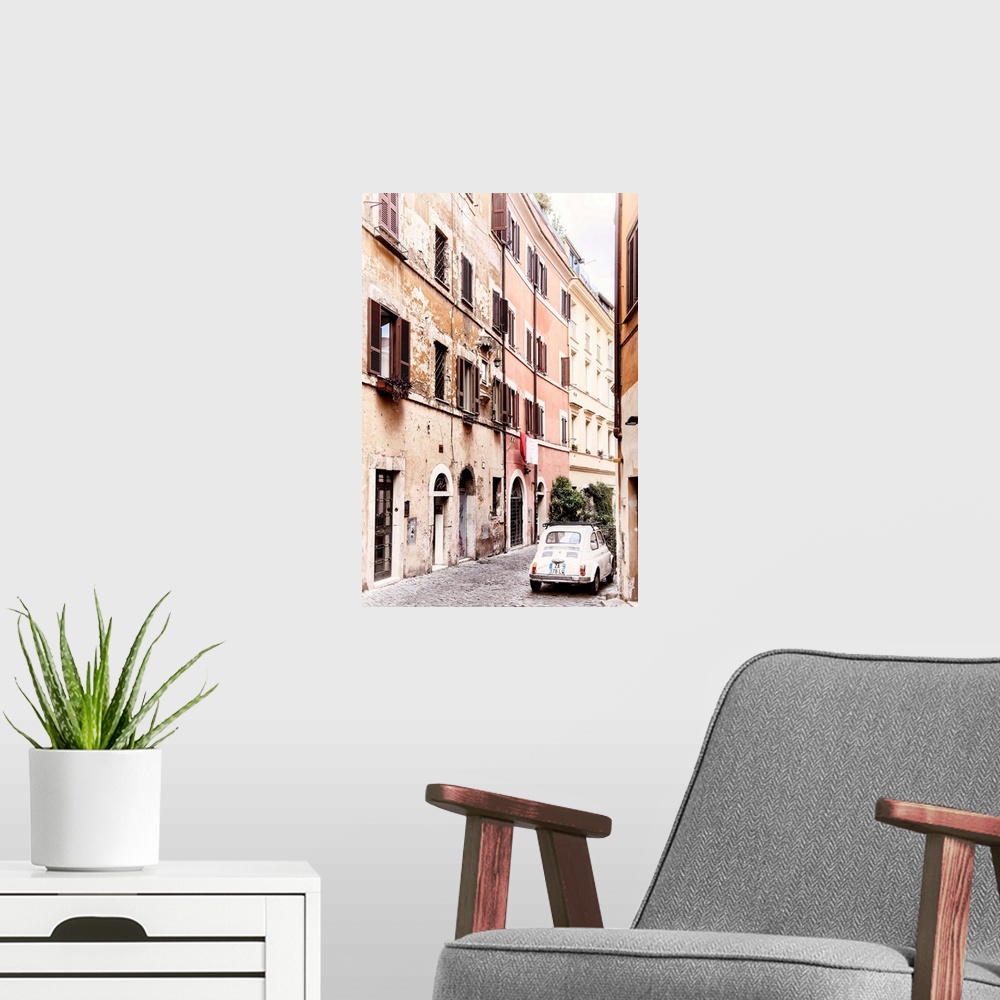 A modern room featuring It's an old white Fiat 500 parked in a beautiful old cobbled street in the center of Rome, Italy.