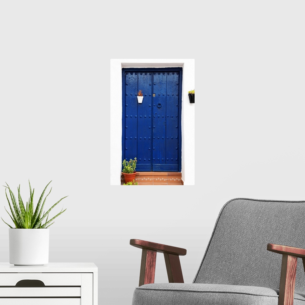 A modern room featuring It's an old blue marine door in Mijas, Spain.