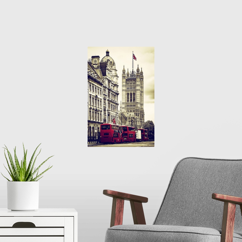 A modern room featuring Row of double decker buses on the street by the House of Parliament in London, England.
