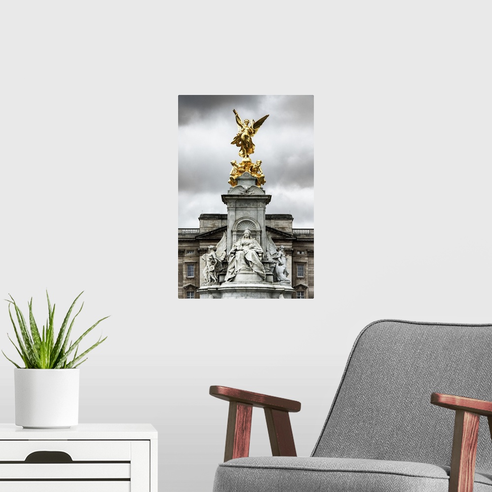 A modern room featuring View of the golden statue at the top of the Victoria Memorial under a cloudy sky.