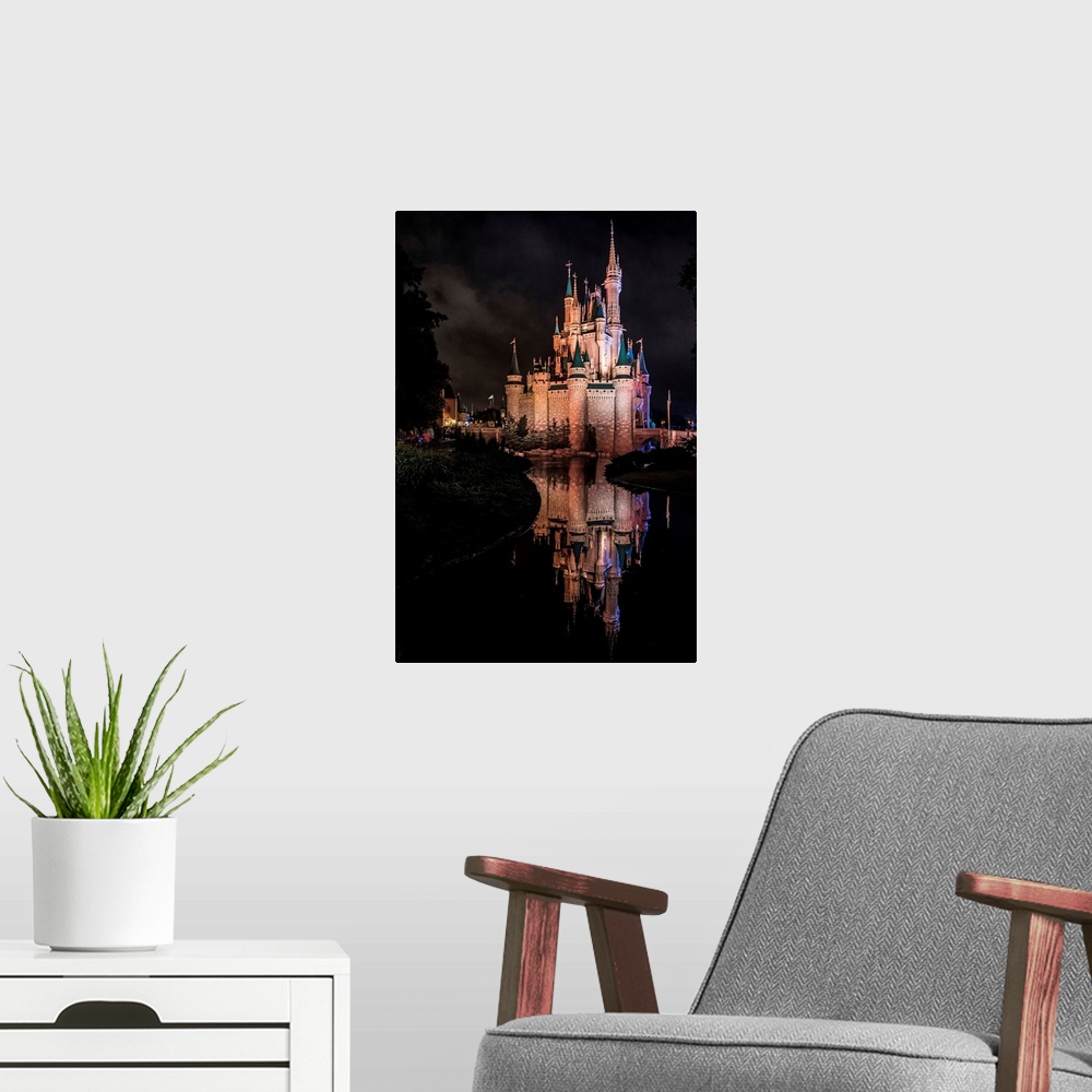 A modern room featuring Cinderella's Castle at Walt Disney World in Orlando, Florida, at night.