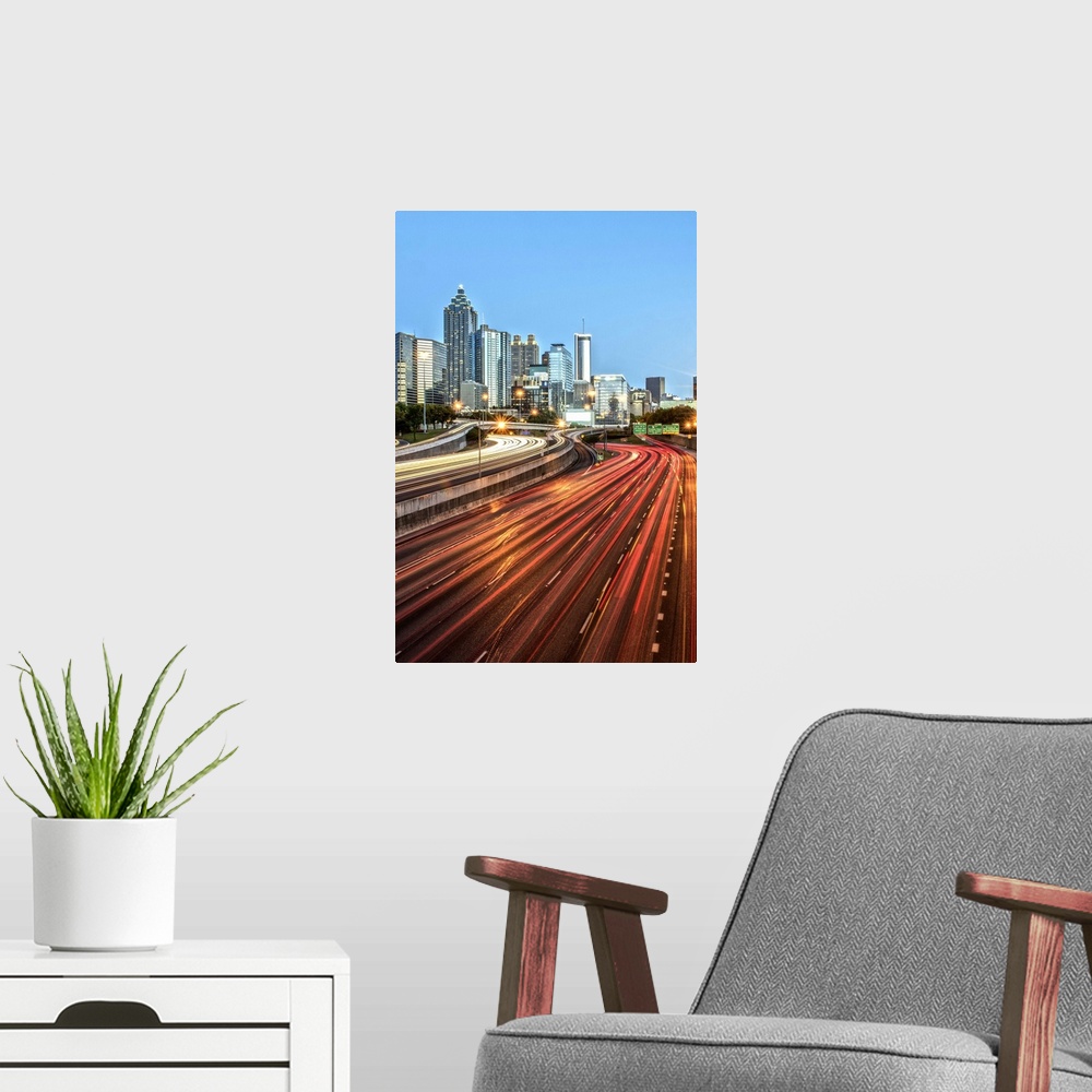 A modern room featuring Light trails on the street from passing vehicles leading towards the city skyline of Atlanta, Geo...