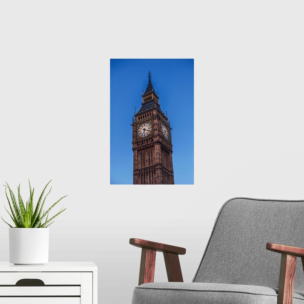 A modern room featuring View of a famous clock tower called Big Ben in London, England at night.