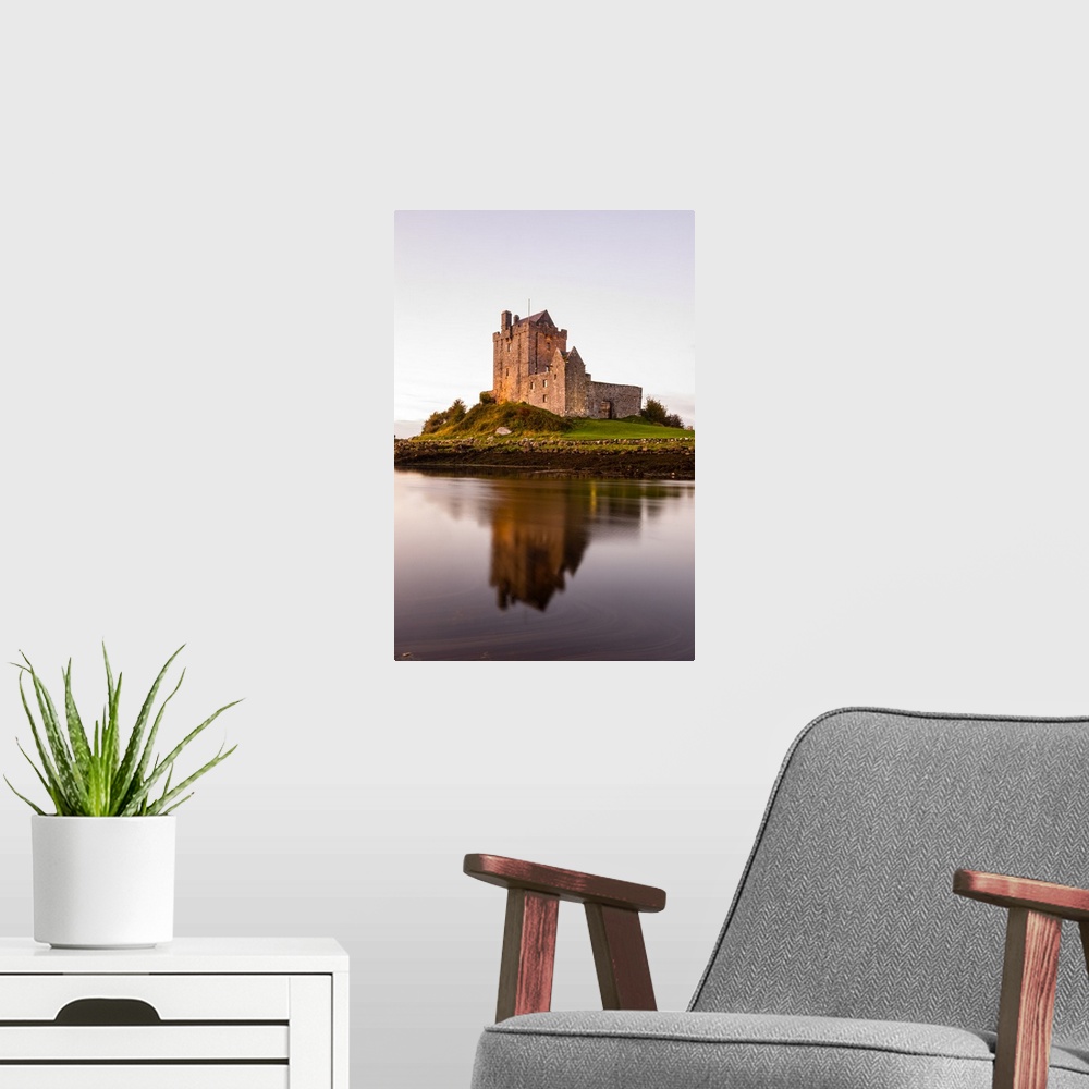 A modern room featuring Vertical photograph of the Dunguaire Castle reflecting into the water on the southeastern shore o...