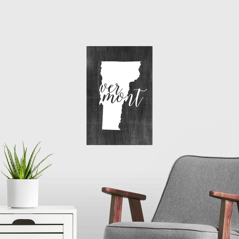 A modern room featuring Vermont state outline typography artwork.
