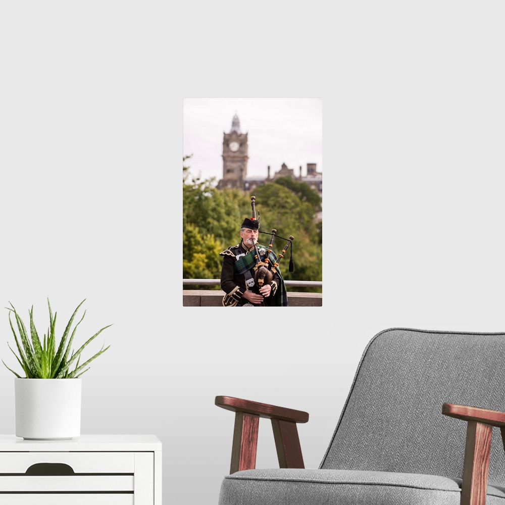 A modern room featuring Photograph of a man playing the bagpipes in Edinburgh with the clock tower blurred out in the bac...