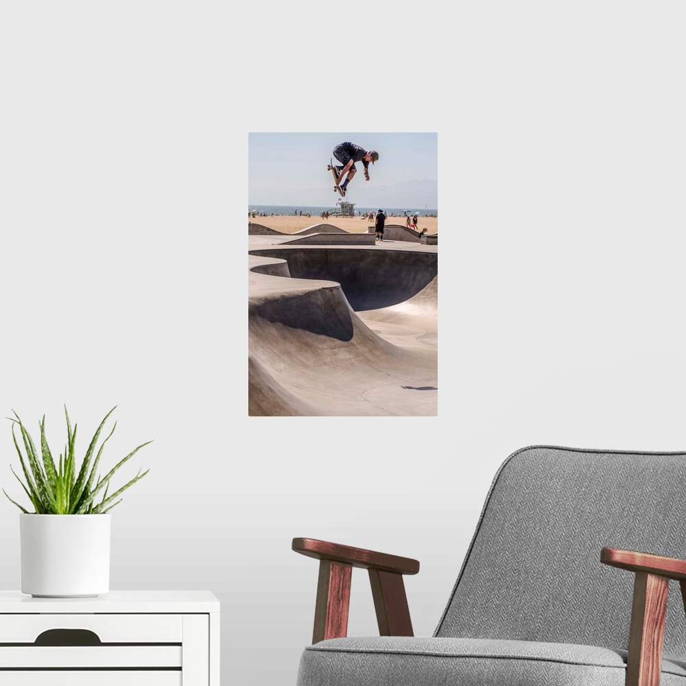 A modern room featuring A local skater is in mid-air at Venice's seaside skate park, Los Angeles.