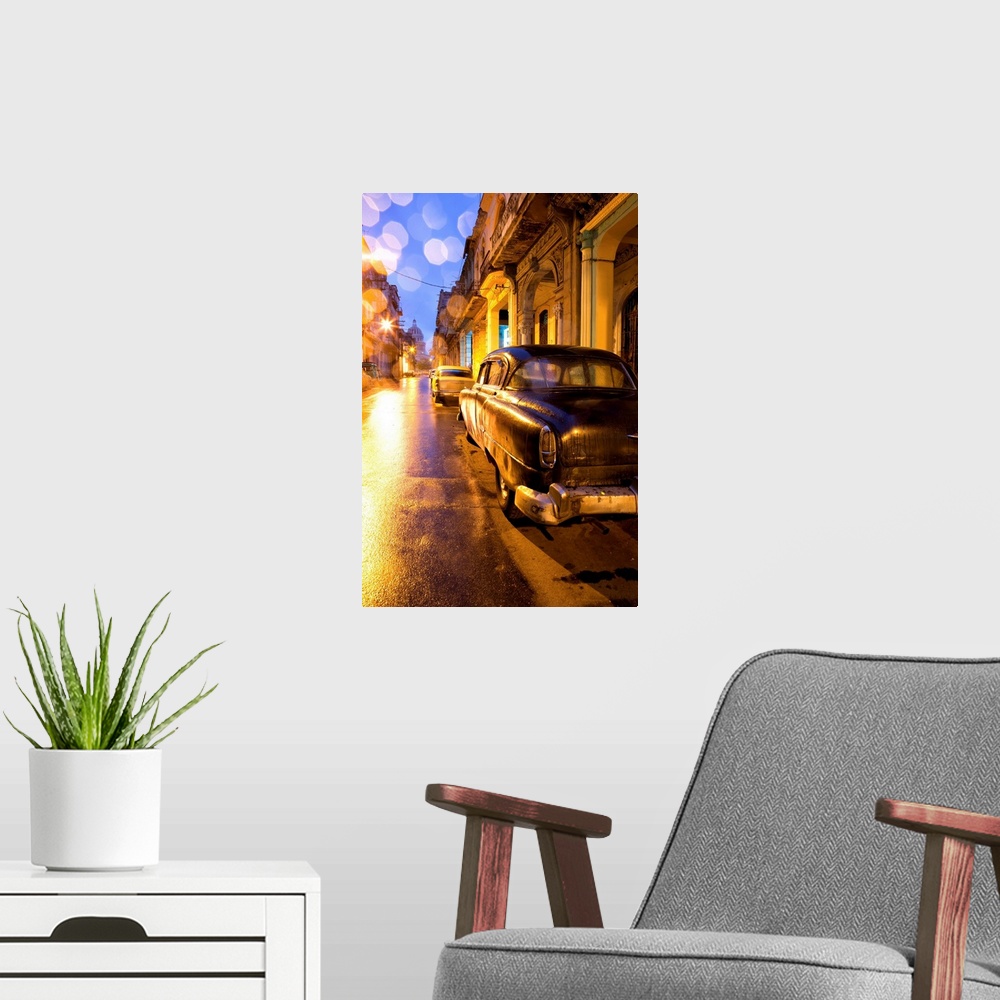 A modern room featuring Low light view along a street towards The Capitolio with street lights reflecting in the wet tarm...