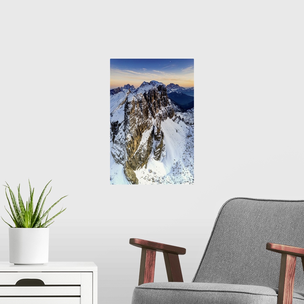 A modern room featuring Aerial panoramic of majestic Nuvolau, Monte Pelmo and Civetta covered with snow at sunset, Dolomi...