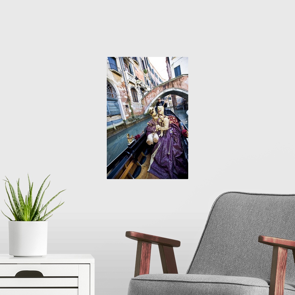 A modern room featuring Couple in Masquerade outfits kissing in Gondola underneath bridge, Venice, Italy