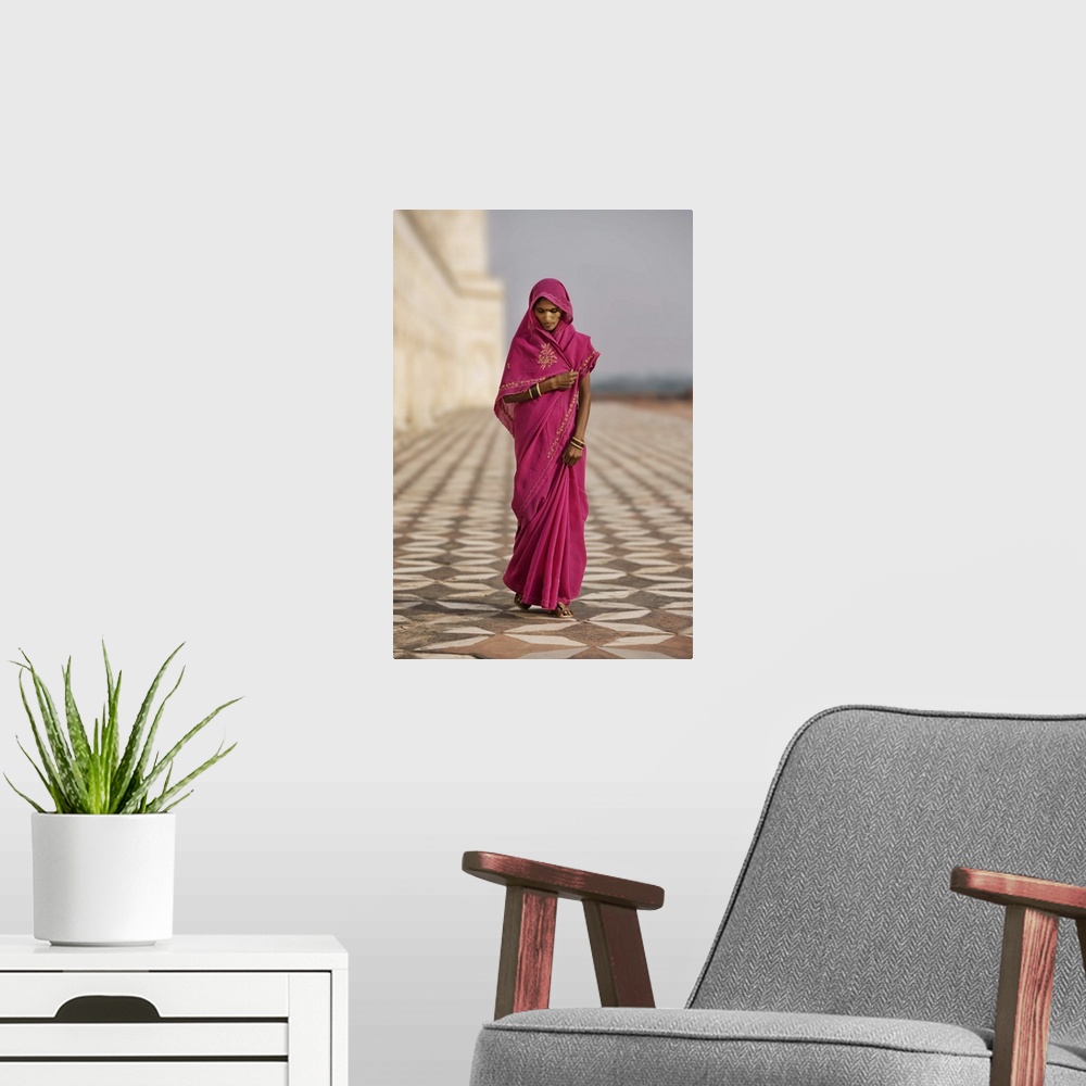 A modern room featuring Indian woman in red dress walking by the Taj Mahal, Agra, India
