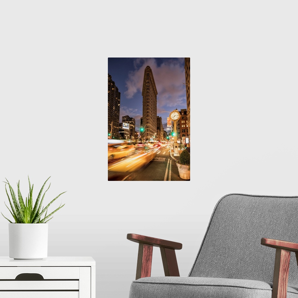 A modern room featuring The Flatiron Building in New York City at sunset