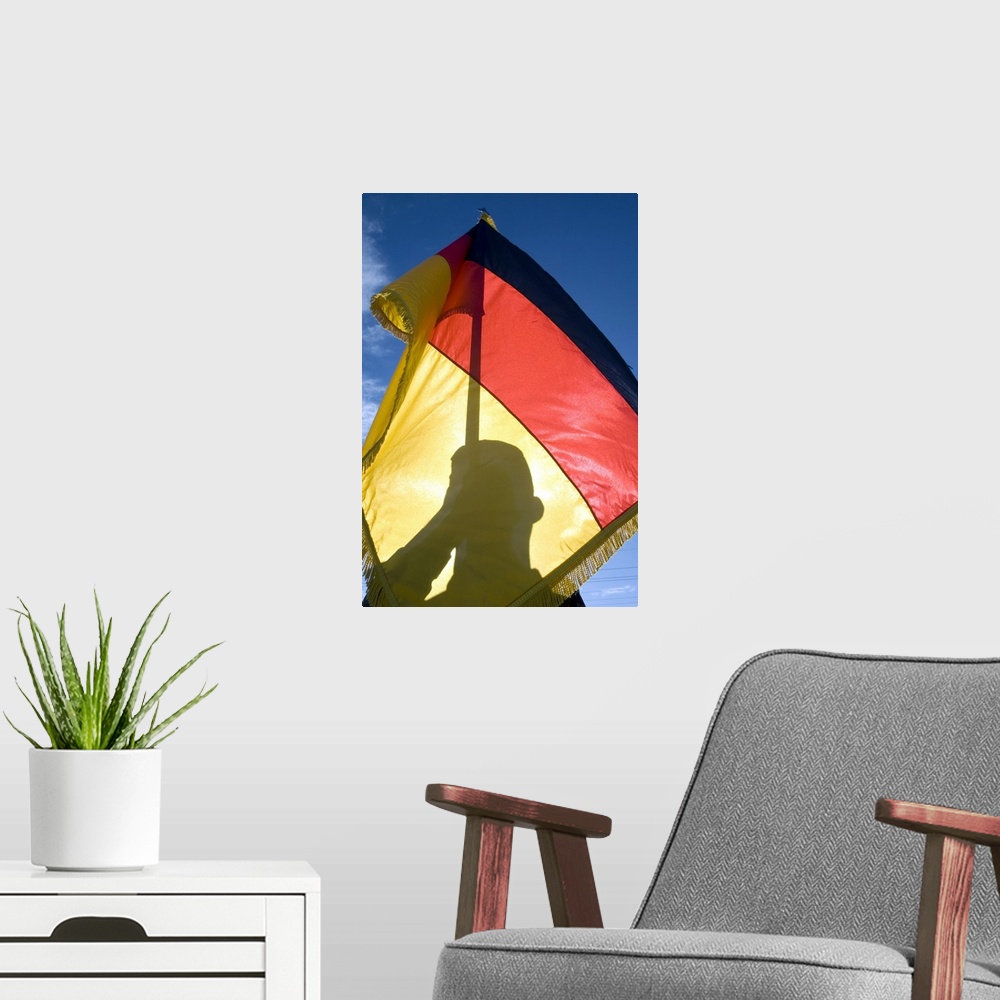 A modern room featuring German Air Force Airman holds the German flag.
