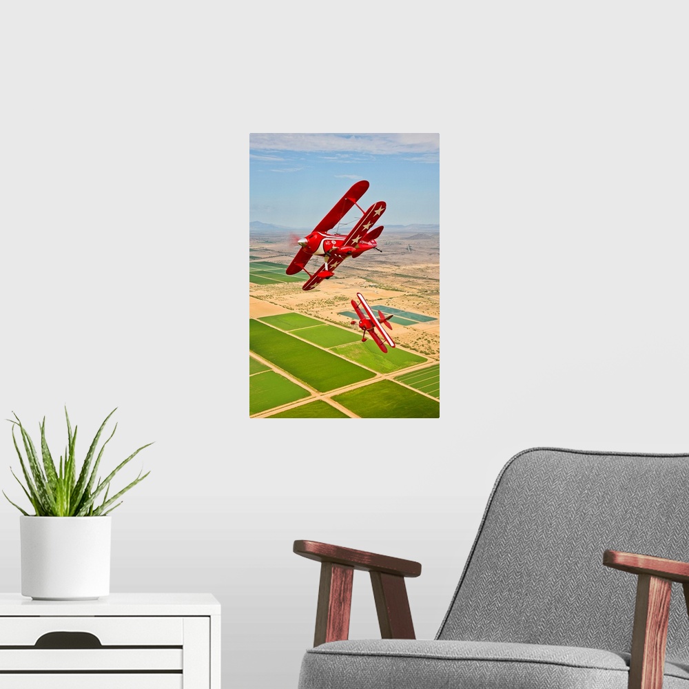 A modern room featuring Two Pitts Special S-2A aerobatic biplanes in flight near Chandler, Arizona.