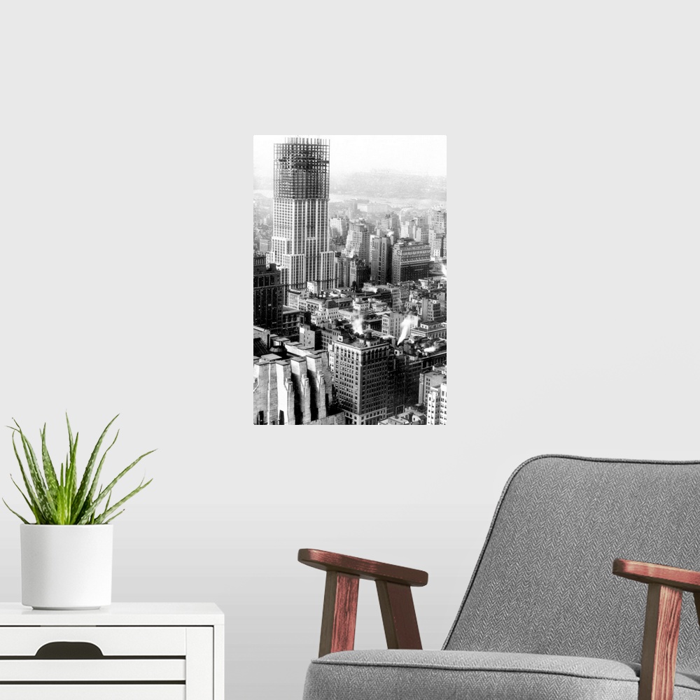 A modern room featuring The Empire State Building, New York City, midway through its construction. Photographed in the fa...