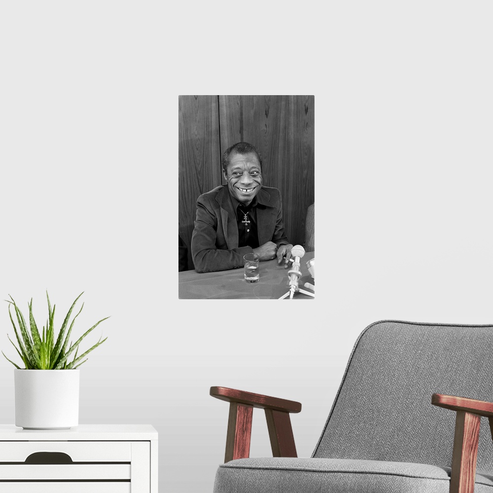 A modern room featuring JAMES BALDWIN (1924-1987). American writer.  Photographed during a press conference for his new b...