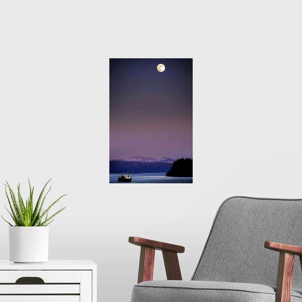 A modern room featuring A full moon at night above snow capped mountains and a ship