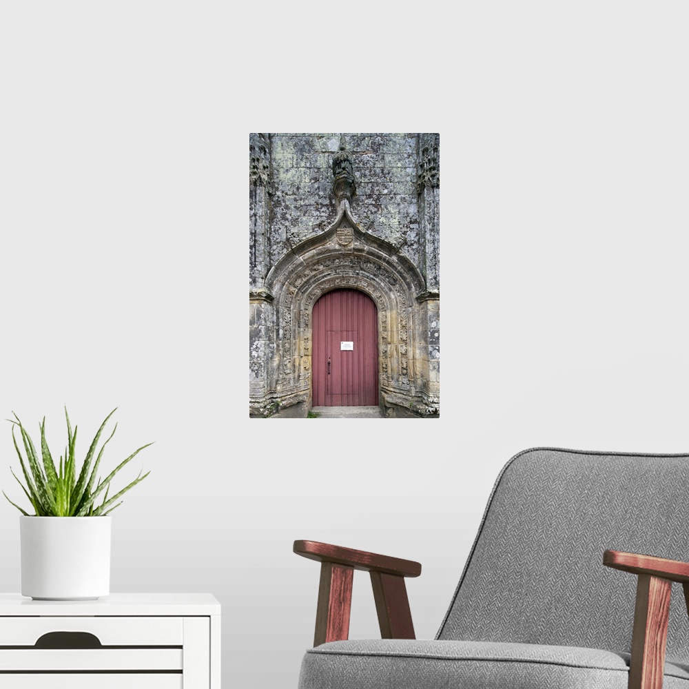 A modern room featuring Entrance door of the Trinity chapel, town of Plumergat, France