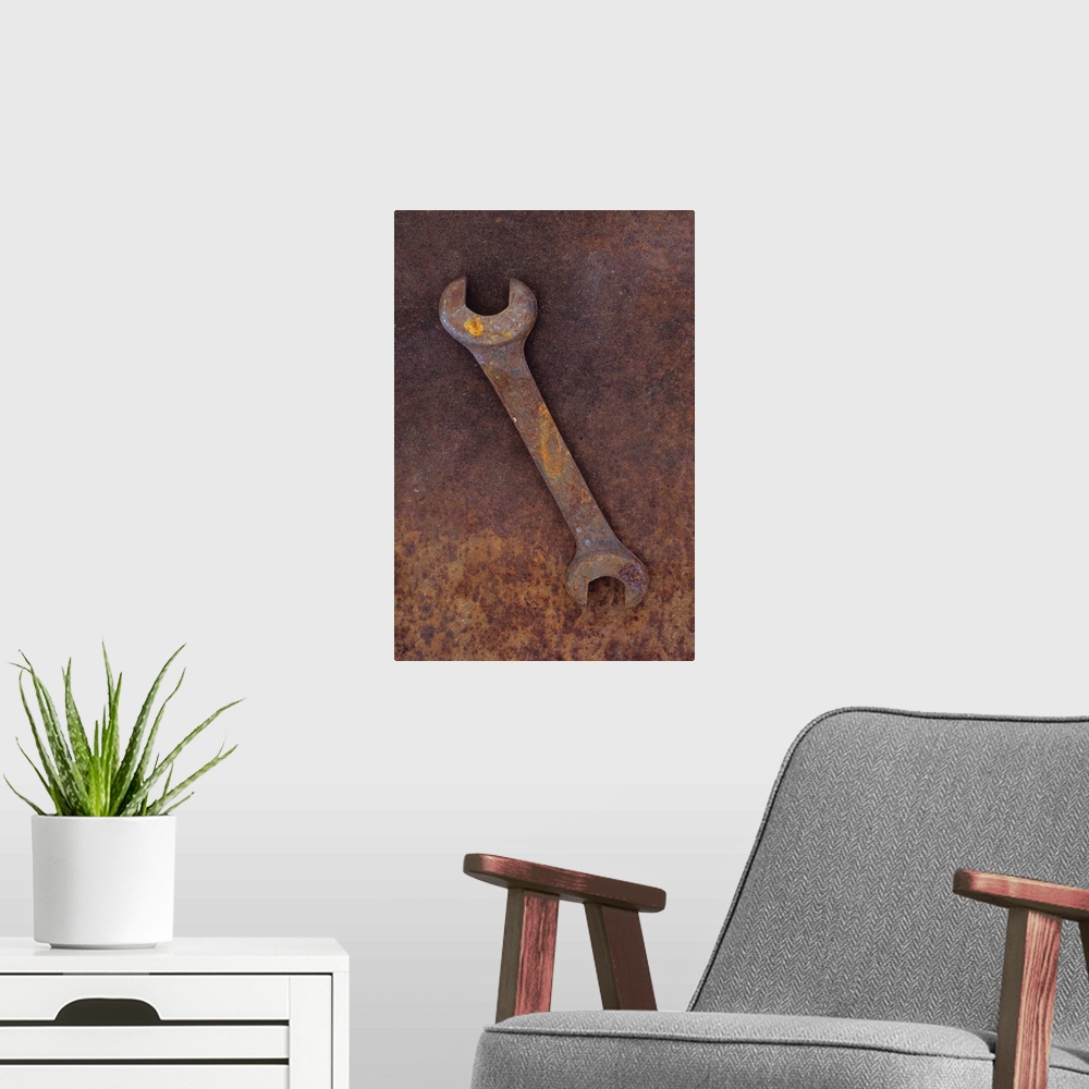 A modern room featuring Heavy double-headed spanner lying on rusty metal sheet