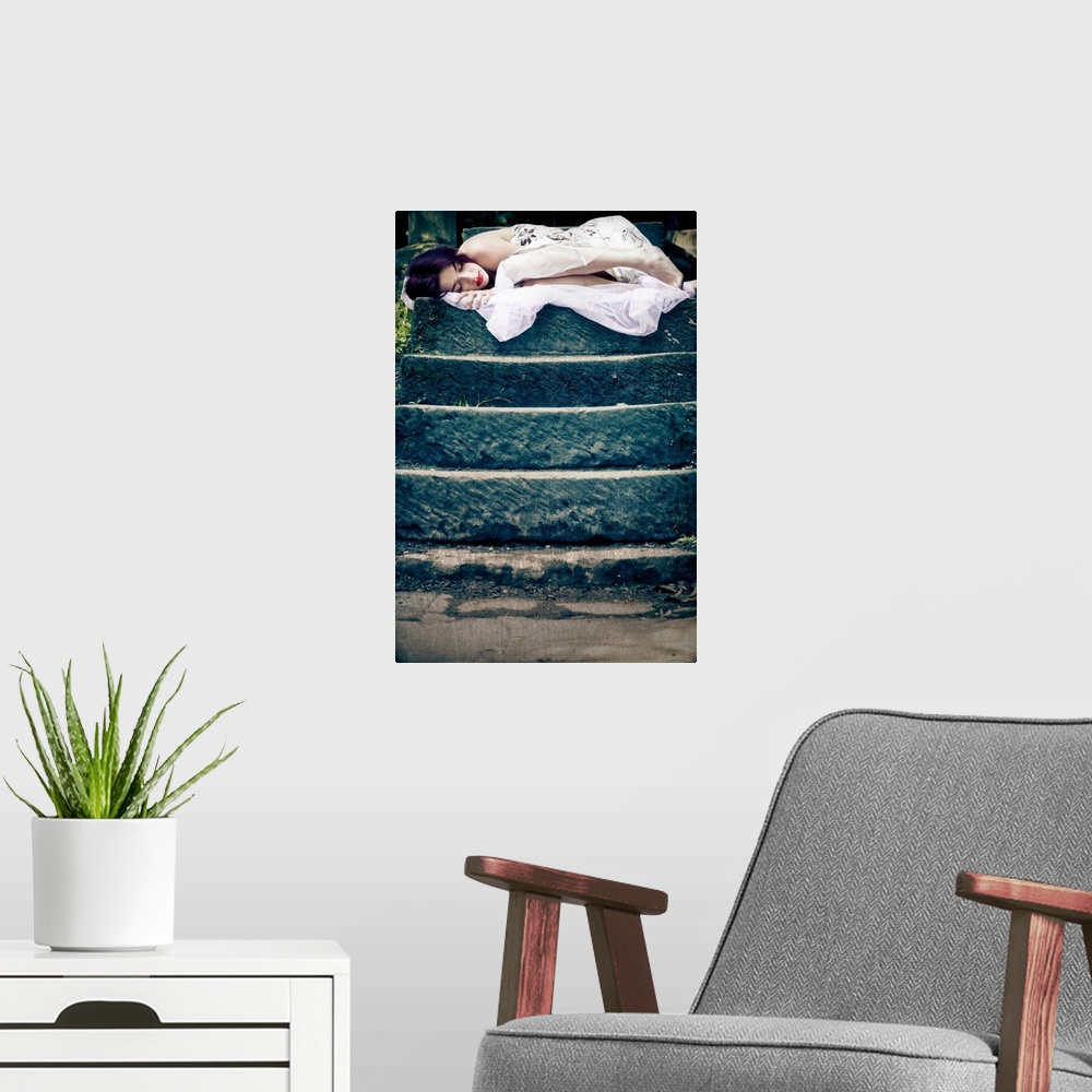 A modern room featuring Image of a sleeping young woman on the top of a set of stone steps in a peaceful garden setting