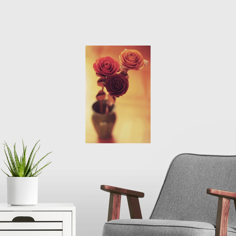 A modern room featuring Three colourful roses in a small vase