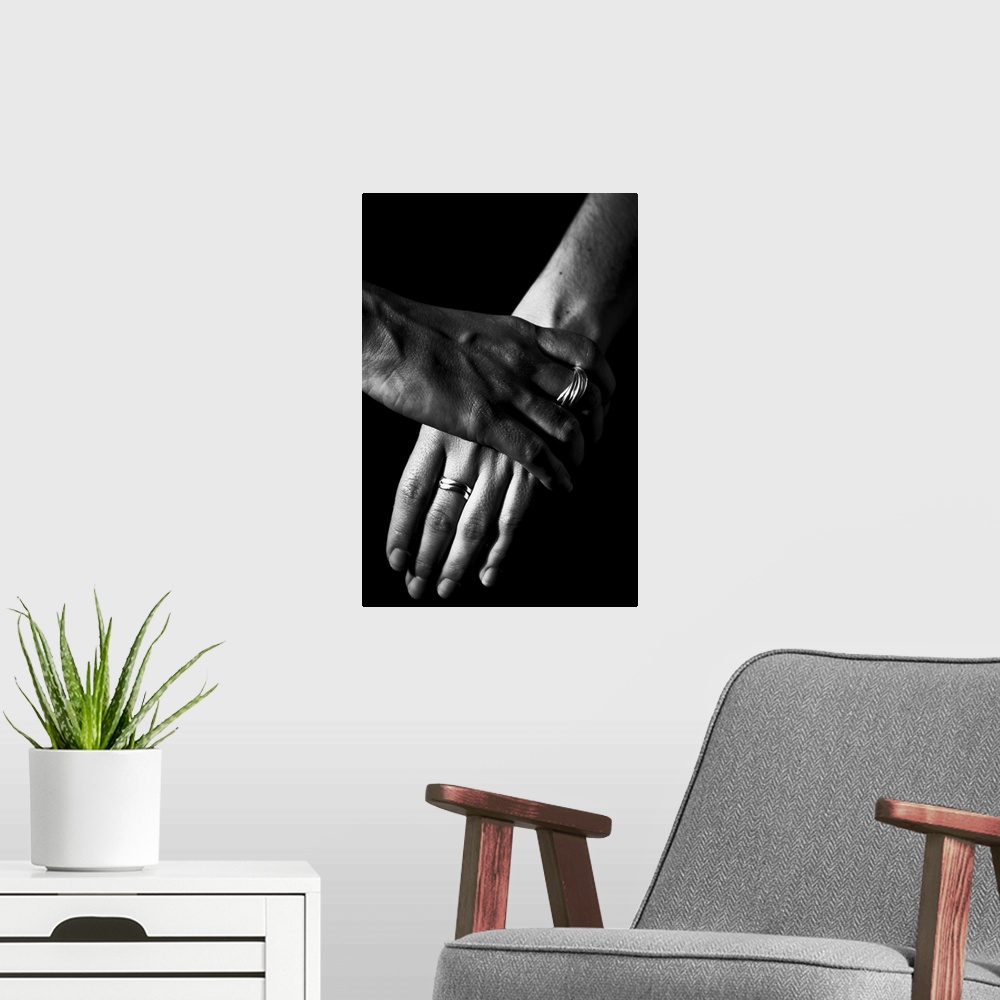 A modern room featuring Two women's hands, over a black background