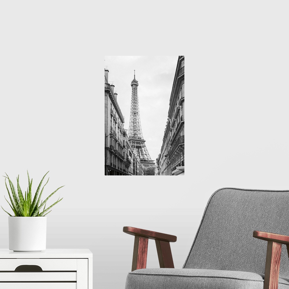 A modern room featuring Black and white photograph of the Eiffel tower seen from street level in Paris.