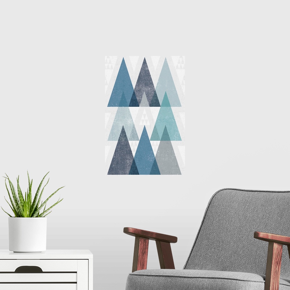 A modern room featuring Abstract artwork with a triangle design in cool blue tones.