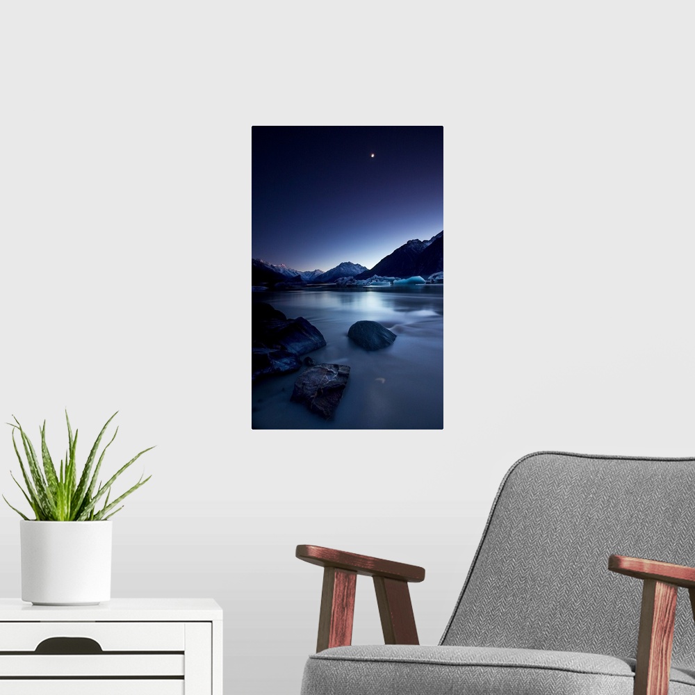 A modern room featuring View of the moon over a river and snowy mountains in the evening, New Zealand.
