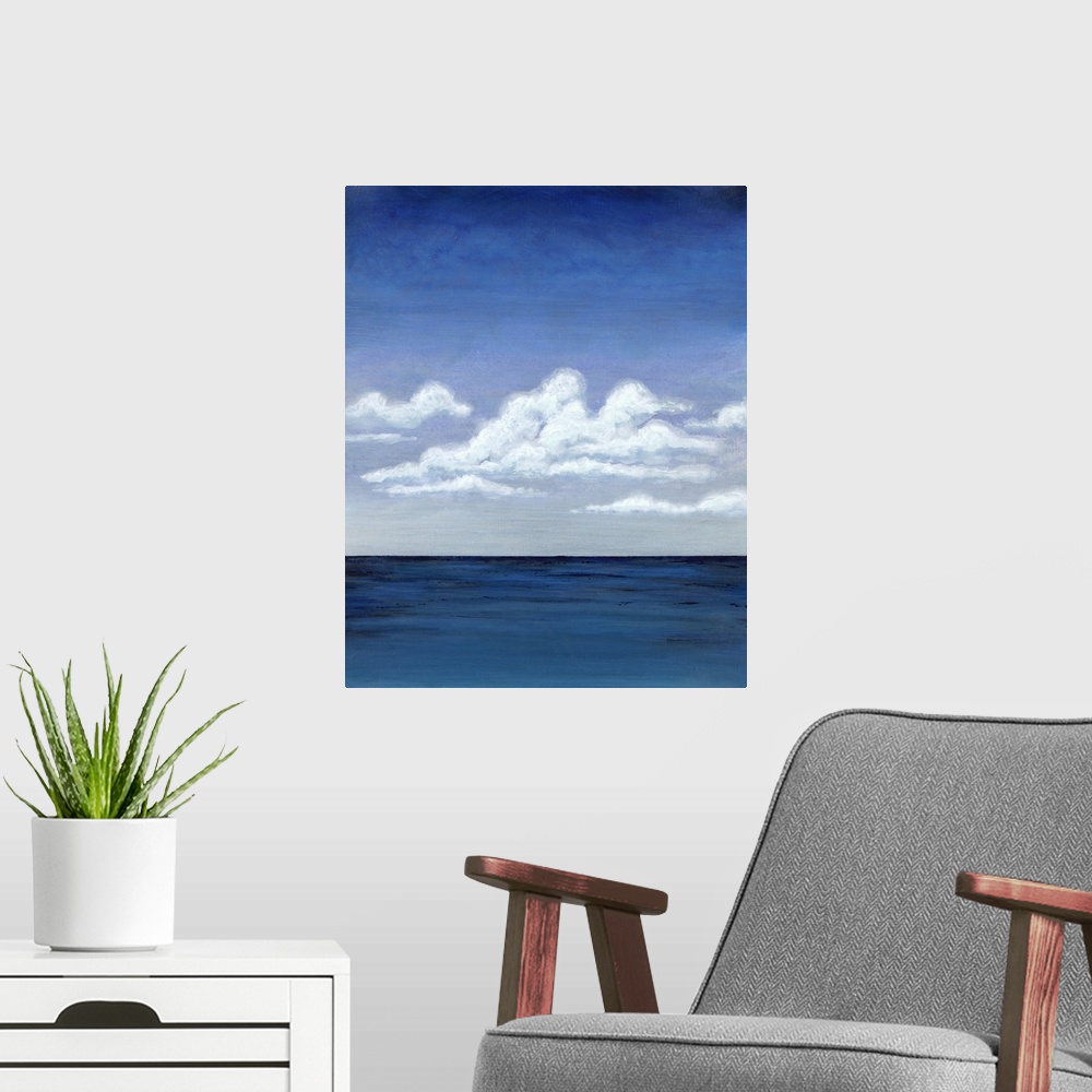 A modern room featuring Contemporary decor art of a seascape under puffy clouds.