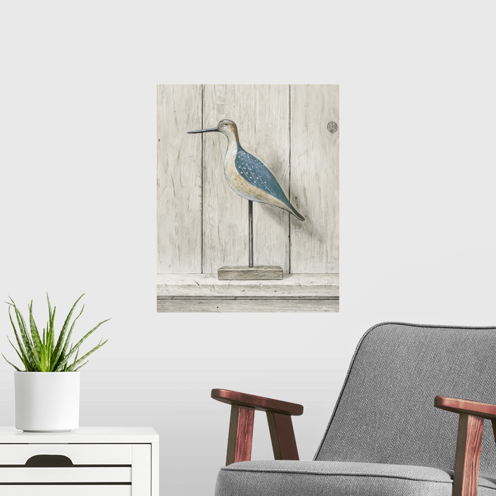 A modern room featuring Contemporary coastal themed artwork of a wooden bird statue against a washed wood background.