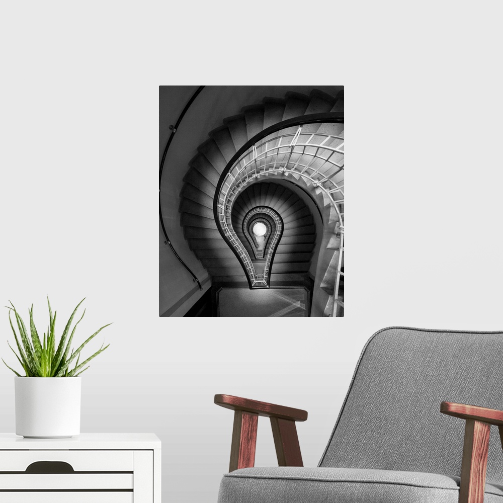 A modern room featuring black and white photograph, stairs, spiral staircase, lightbulb