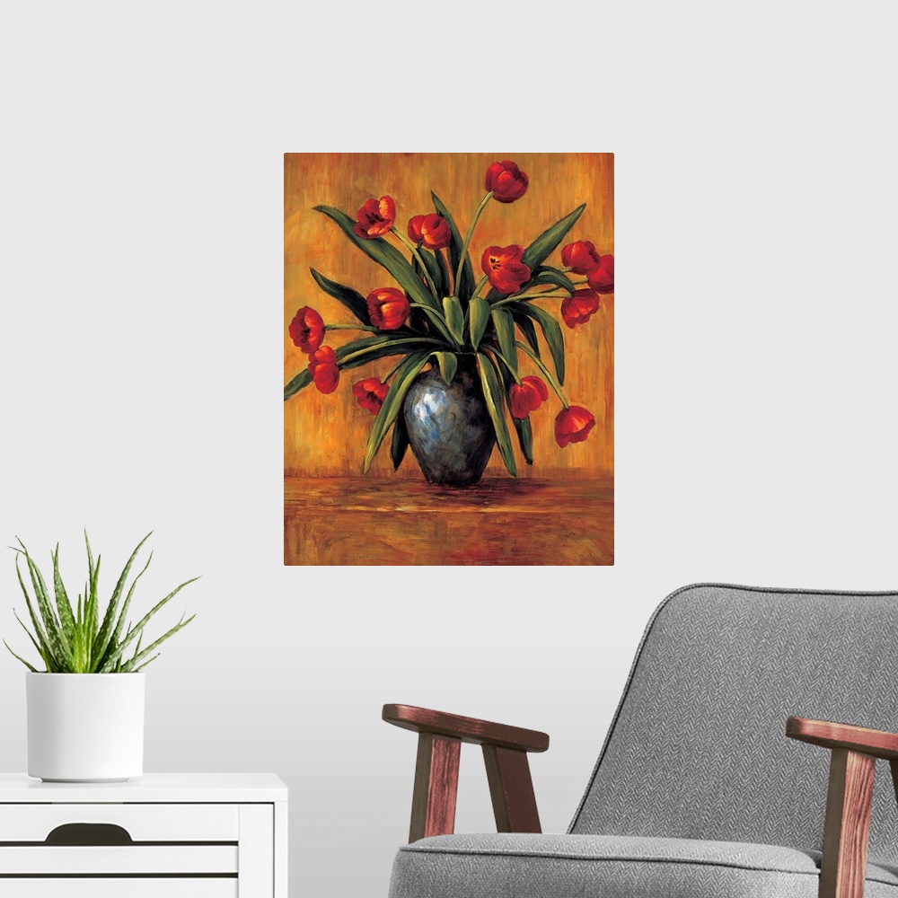 A modern room featuring Contemporary painting of red tulips in a vase with an orange, red, and brown background.