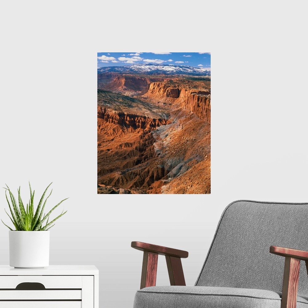 A modern room featuring View from Navajo Knobs at the summit of Capitol Reef. Cliffs and badlands (Wingate, Chinle, and M...